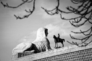 Sphinx and equestrian statue in monochrome