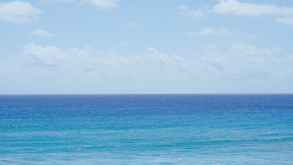 View of the blue sea and clear sky with clouds