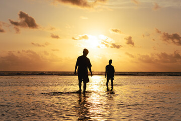 visitors are enjoying the sunset on the coast. enjoying a holiday on the beach