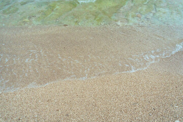 white sand with calm small waves on the coast