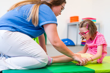 Child with physical disability in physical therapy session. Child living with cerebral palsy...