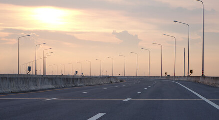 Panoramic city skyline and mountain with empty asphalt road at sunset
