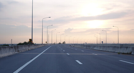 Panoramic city skyline and mountain with empty asphalt road at sunset