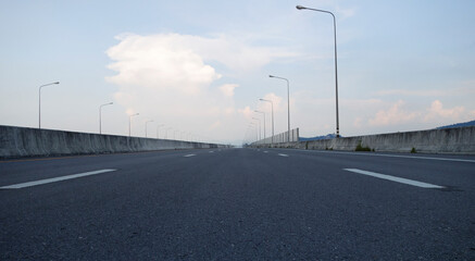 Panoramic city skyline and mountain with empty asphalt road at sunset