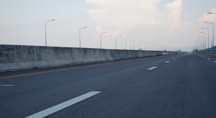 Panoramic city skyline and mountain with empty asphalt road at sunset