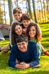 Family having fun together lying on the forest