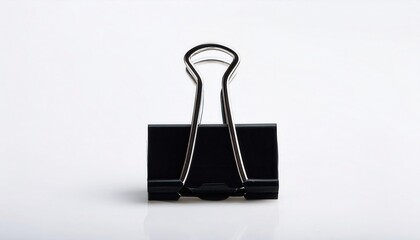 A black binder clip isolated on a clean background.