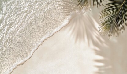 Tropical beach with palm leaf shadows on fine white sand and shimmering water reflection under sunlight