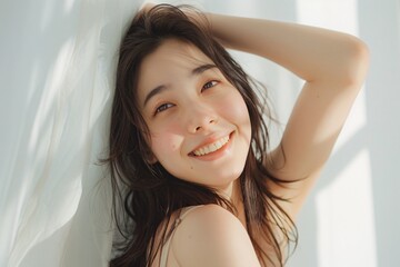 Glamorous portrait of an Asian woman with flawless makeup and hair lit by sunlight