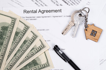 Rental or Residential Lease agreement contract, magnifying glass, dollar money cash, and house keys. Short and long term rentals, housing searching crisis, signing lease agreement, and rising prices.