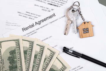 Rental or Residential Lease agreement contract, magnifying glass, dollar money cash, and house keys. Short and long term rentals, housing searching crisis, signing lease agreement, and rising prices.