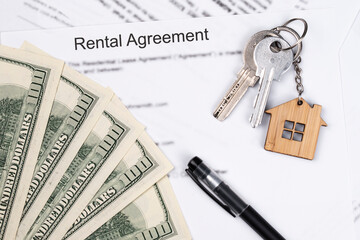 Rental or Residential Lease agreement contract, magnifying glass, dollar money cash, and house keys. Short and long term rentals, housing searching crisis, signing lease agreement, and rising prices.