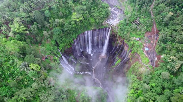 High angle drone aerial view surround of sewu waterfall and jungle in east java, indonesia
