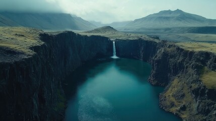 Aerial View of the Majestic Icelandic Landscape Featuring Scenic Waterfall and Rugged Mountains