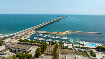 Naklejka premium Aerial view of a long jetty on the Mediterranean Sea.