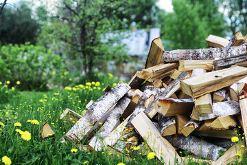 Chopped firewood lies in the woodpile. Wooden background.