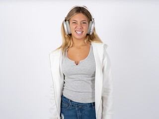Portrait of dissatisfied Beautiful teen girl wearing white jacket smirks face, purses lips and...