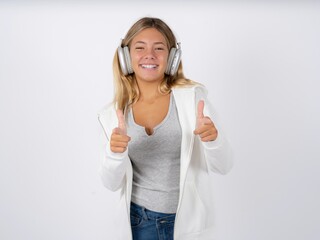 Beautiful teen girl wearing white jacket directs fingers at camera selects someone. I recommend you. Best choice