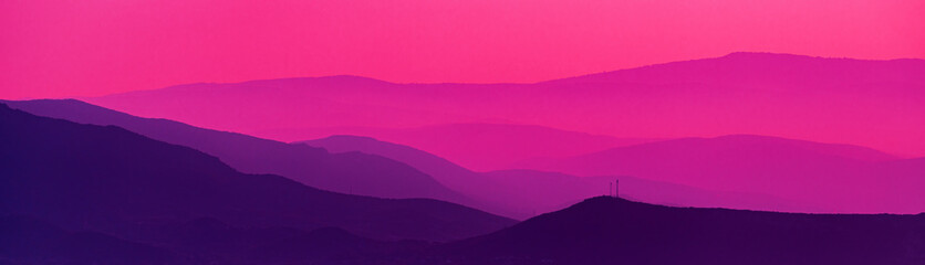 Mountain landscape, purple toned scenic back lit hills of mountain range in morning