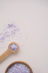Lavender bath salt in wooden spoon, top view.