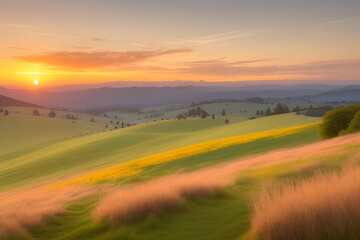 Fototapeta premium A vibrant sunset paints the sky with hues of orange, yellow, and pink, casting a warm glow over rolling hills and a lush, green meadow. The sun dips below the horizon, leaving a trail of light across 