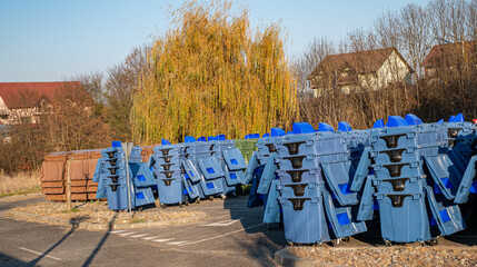 rows of new municipal colored trash cans with wheels