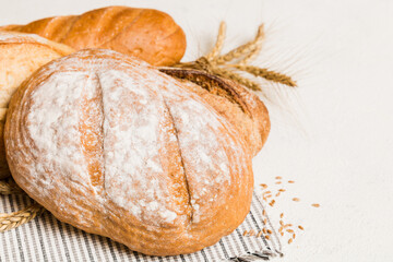 Homemade natural breads. Different kinds of fresh bread as background, perspective view with copy space