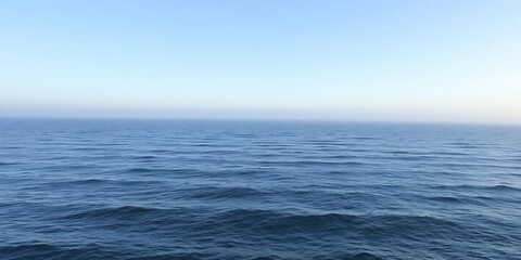 Fototapeta premium Serene sea landscape with a few wisps of morning fog and gentle ripples, gentle ripples, ocean views