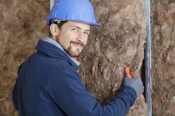 cheerful plasterer worker looking at camera
