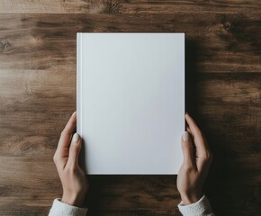 Obraz premium Blank Book Held in Hands on Wooden Table