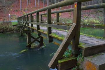 old wooden bridge with moss across the pegnitz river countryside of nuremberger land