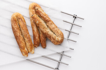 Freshly Baked Food Savory Pastries on Metal Rack, greek cheese pie or bulgarian butter banitsa for...