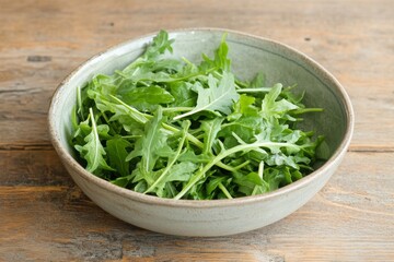 Freshly Harvested Arugula Leaves in a Shallow Bowl on Rustic Wooden Table Surface Highlighting Organic Healthy Eating and Culinary Concepts