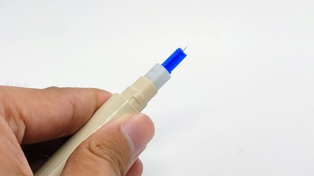 Installing blood lancet needle on white background