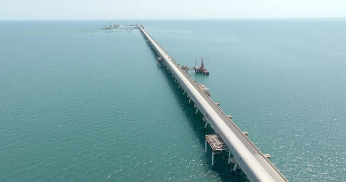 Aerial view of a long pier on the Mediterranean Sea.