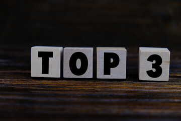 wooden cube with the word Top 3. the concept of the winner in the bottom three. first to third prize giving event