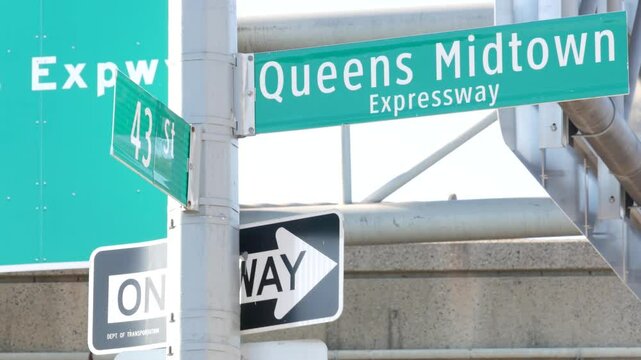 Queens Midtown signboard. Brooklyn Queens expressway road sign, New York City highway signage, green traffic roadsign shield, United States transportation. One way arrow.