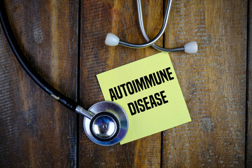 Top view image of stethoscope with Autoimmune Disease wording on yellow memo pad. Medical concept