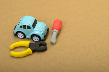 Fototapeta premium Toy Car and Service Tools, Depicting Car Maintenance, Repair, and Automotive Industry Concepts