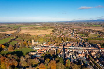 Aerial photo of the beautiful town of Bedale which is a market town in the Hambleton former district of North Yorkshire showing the beautiful town, church and motorway in the autumn time
