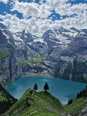 Two pine trees above the turquoise lake surrounded by mesmerising mountains and glaciers