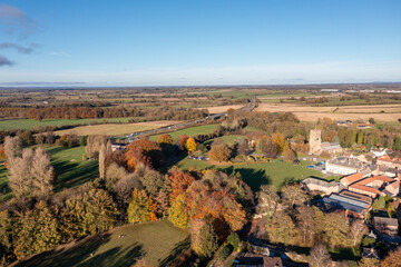 Aerial photo of the beautiful town of Bedale which is a market town in the Hambleton former district of North Yorkshire showing the beautiful town, church and motorway in the autumn time