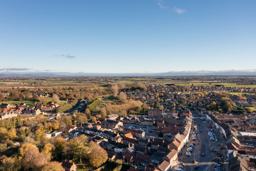 Aerial photo of the beautiful British town of Bedale which is a market town in the Hambleton former district of North Yorkshire in the UK showing houses and housing estates in the Autumn time