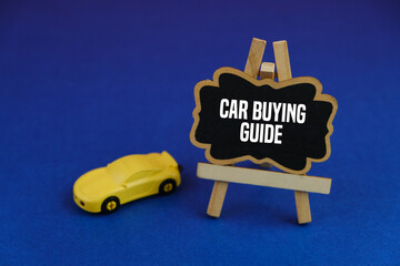 miniature of car and notice board with the word car buying guide