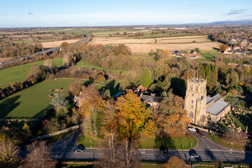Aerial photo of the beautiful town of Bedale which is a market town in the Hambleton former district of North Yorkshire showing the beautiful town, church and motorway in the autumn time