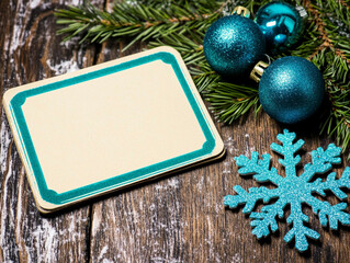 Holiday table decorations, top view: a blank centerpiece framed with natural pine branches, shimmering blue ornaments, intricate snowflakes and a small wrapped gift. Balanced composition for creating 