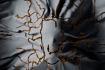 Mannequin head covered with gray fabric and gold pattern