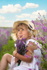 Fototapeta premium Child girl in lavender field. Selective focus.