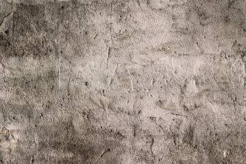 The photo shows an old brown concrete wall