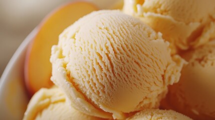 Creamy peach ice cream scoop with smooth texture, topped with fresh peach slices for an inviting and refreshing dessert presentation.
